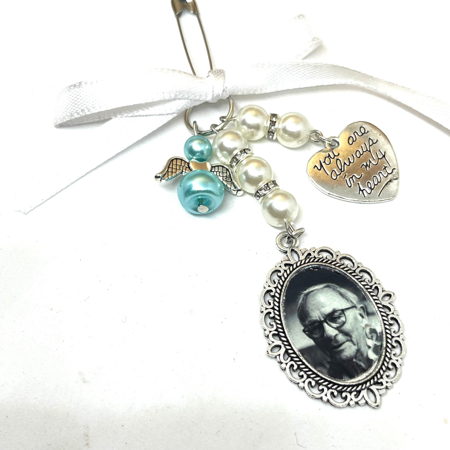 Single silver wedding bouquet charm with pearls, diamantes and an angel on a white ribbon.