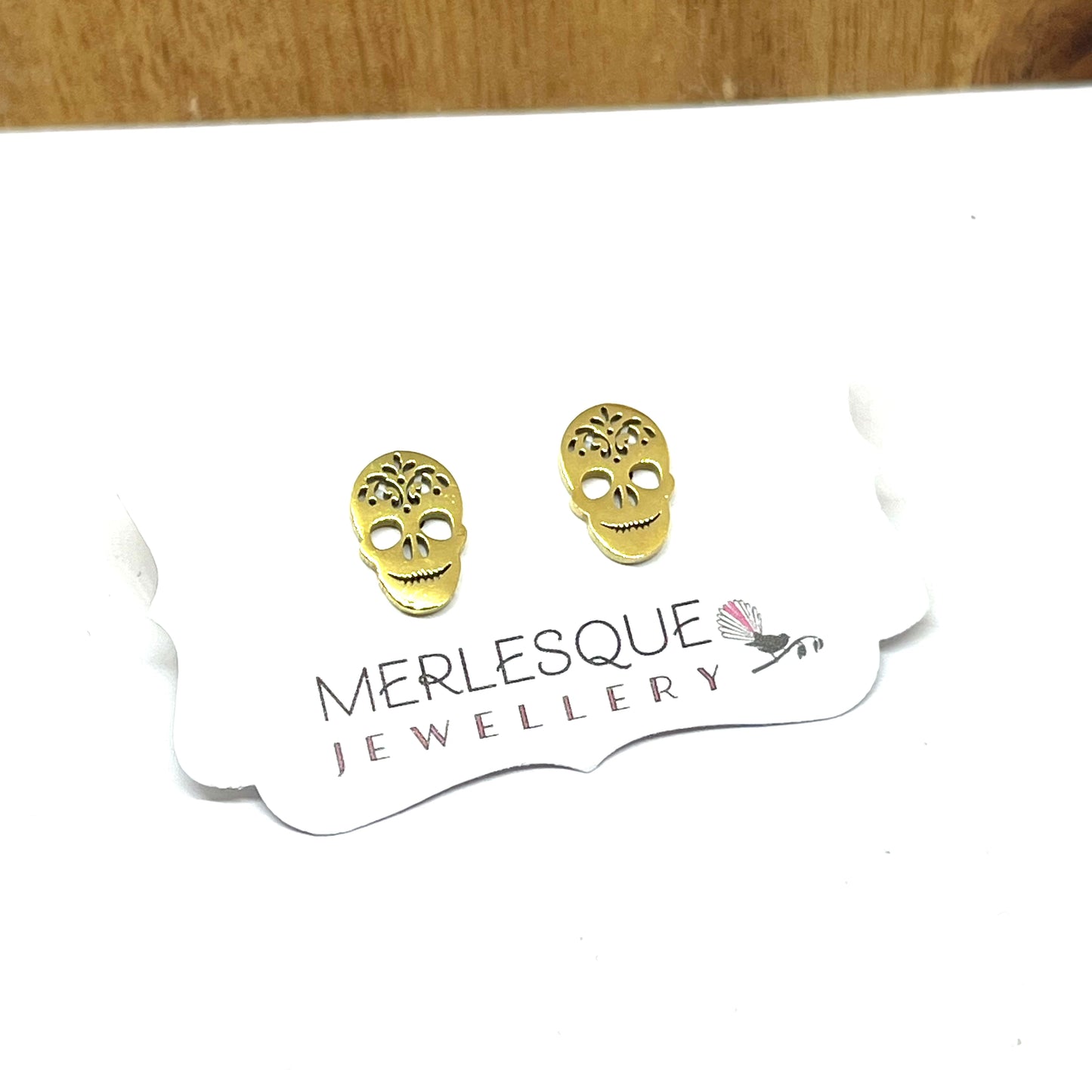 Stainless steel gold skull studs.