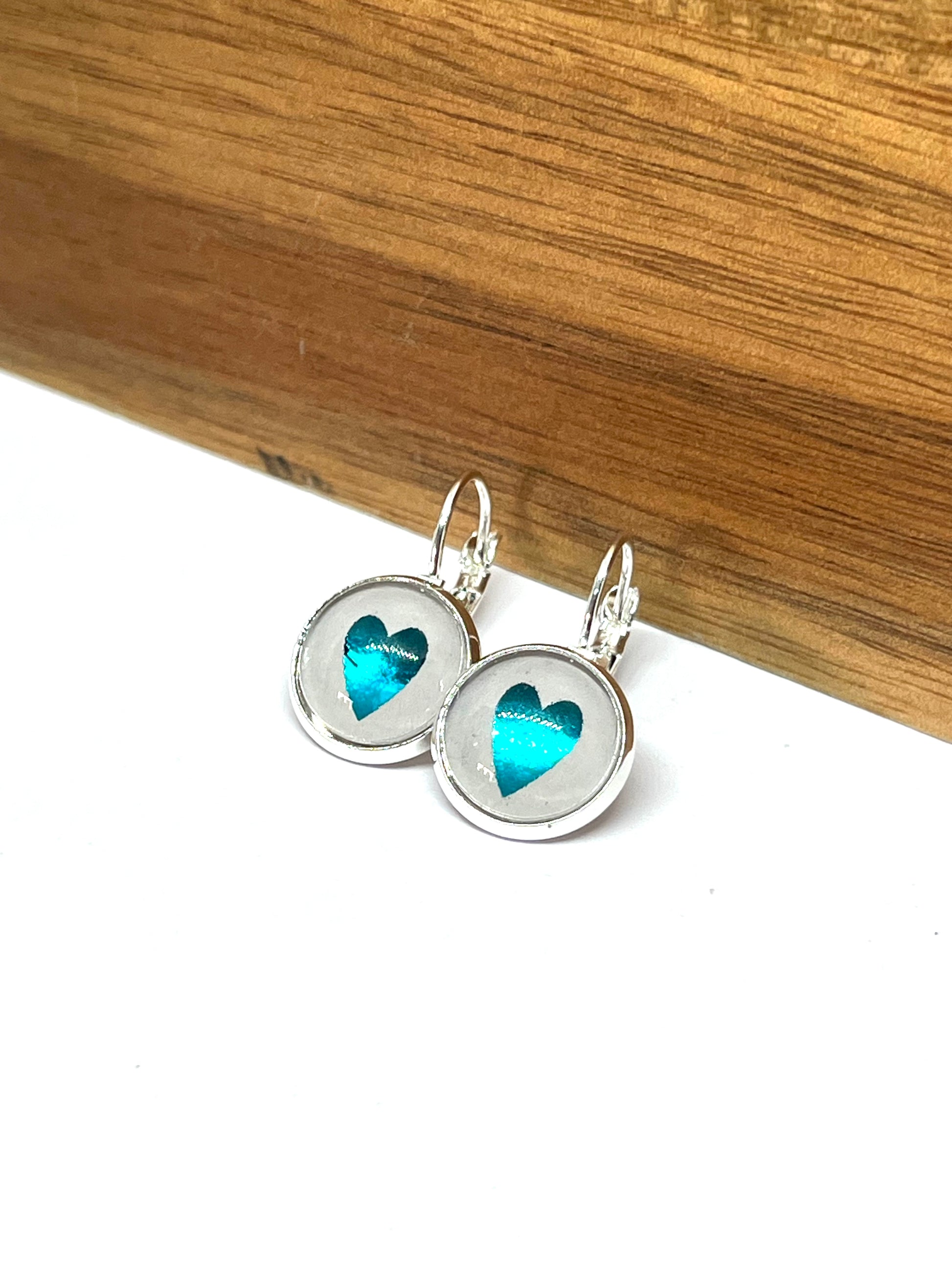Pretty Aqua blue heart glass dome earrings in a silver setting
