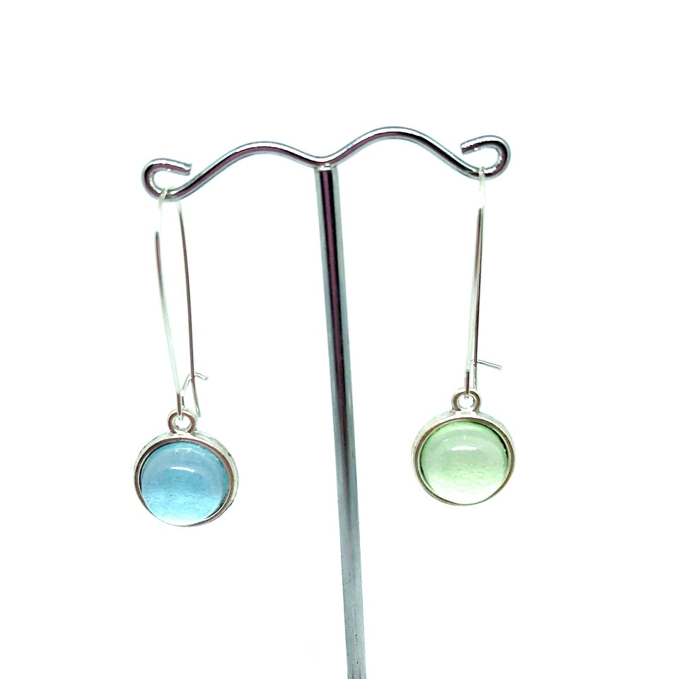 Double sided glass dome earrings with pastel blue on one side and soft green other side