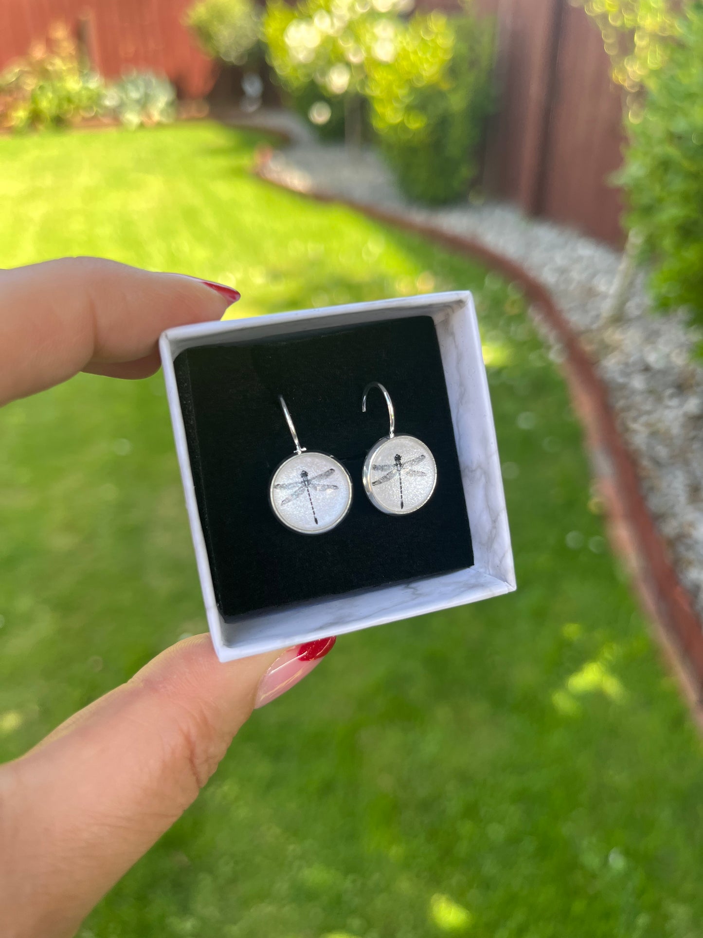 pretty black dragonflies on a pearl background glass dome earrings
