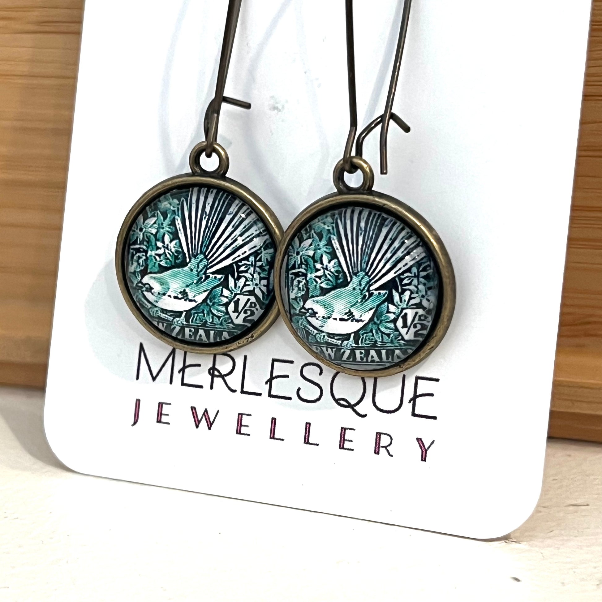 Long green glass dome fantail (Piwakawaka) earrings