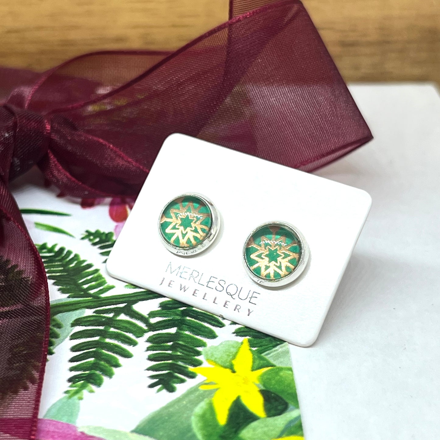 Green and rose glass dome snowflake studs.