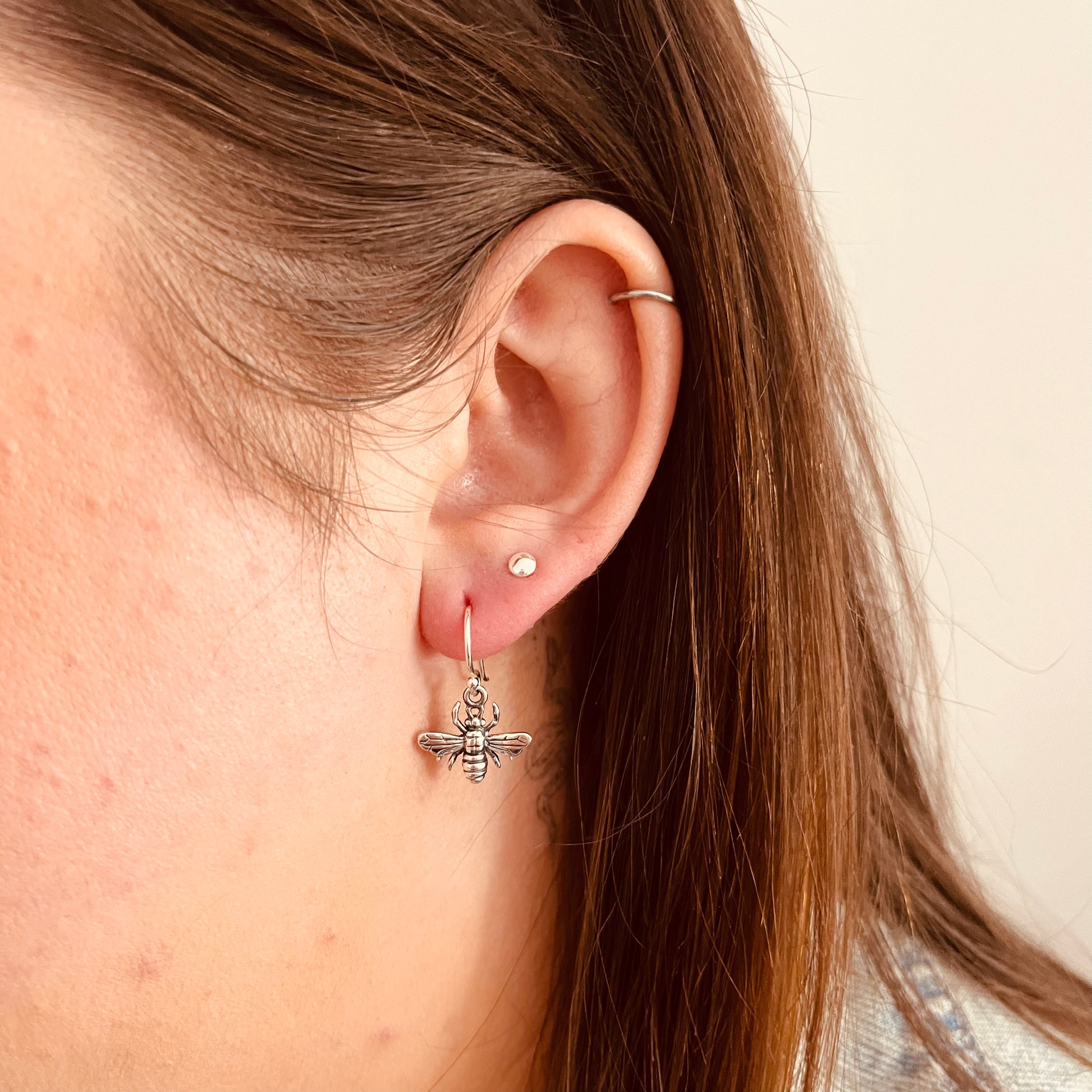 Sterling silver honey bee earrings on model