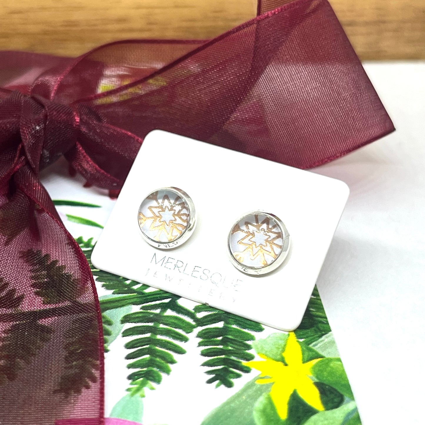 White and rose glass dome snowflake studs.