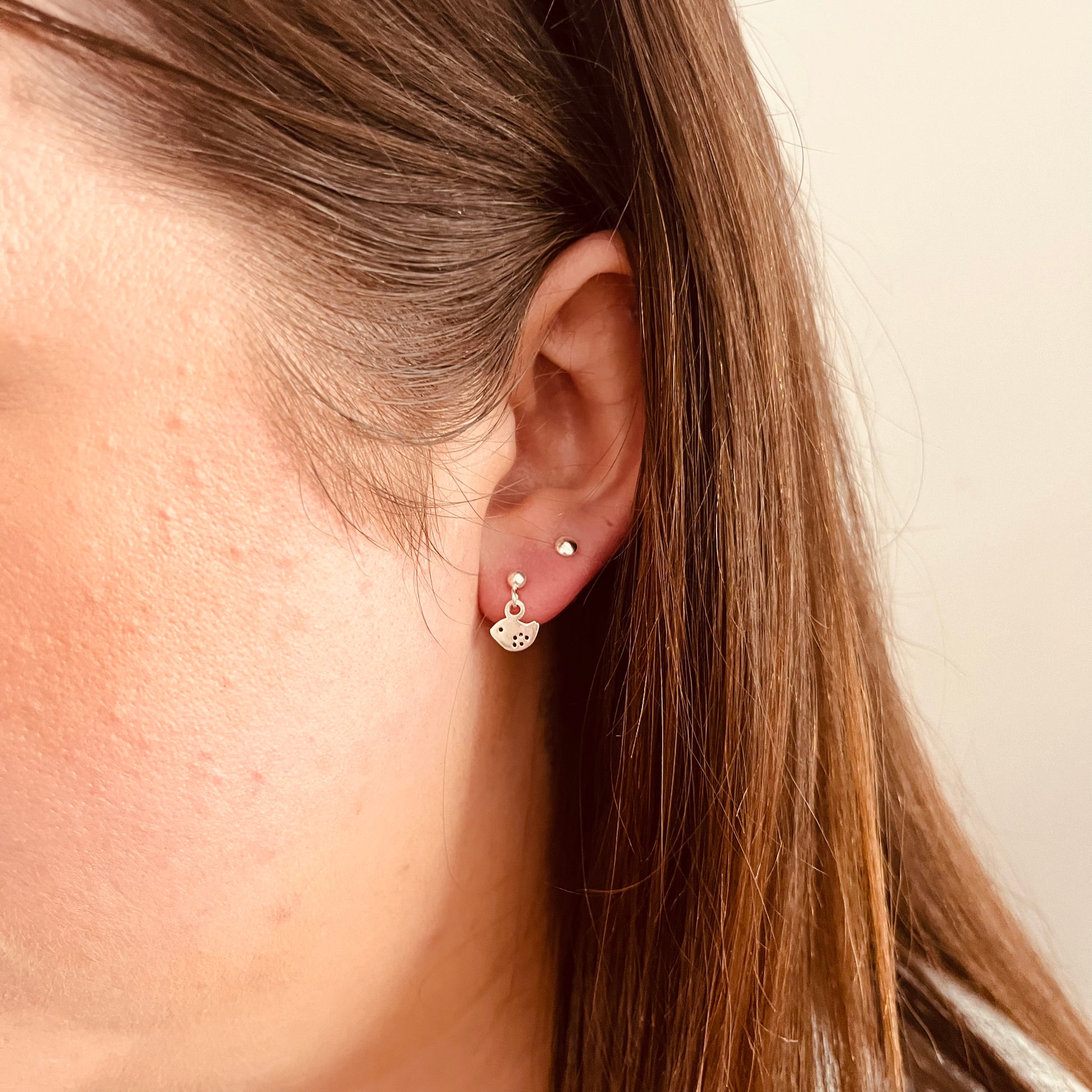 Sterling silver dove earrings on model