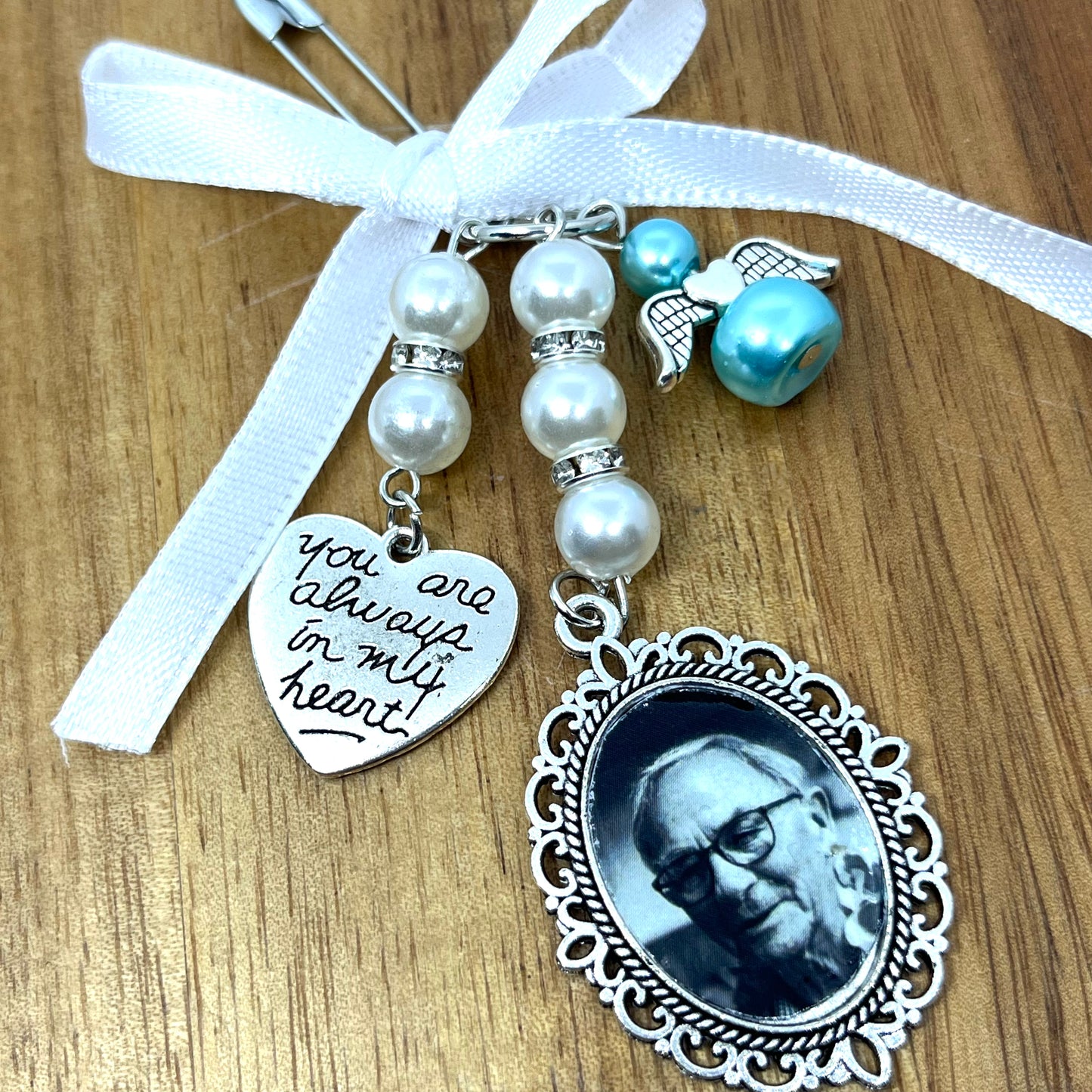 Single silver wedding bouquet charm with pearls, diamantes and an angel on a white ribbon.