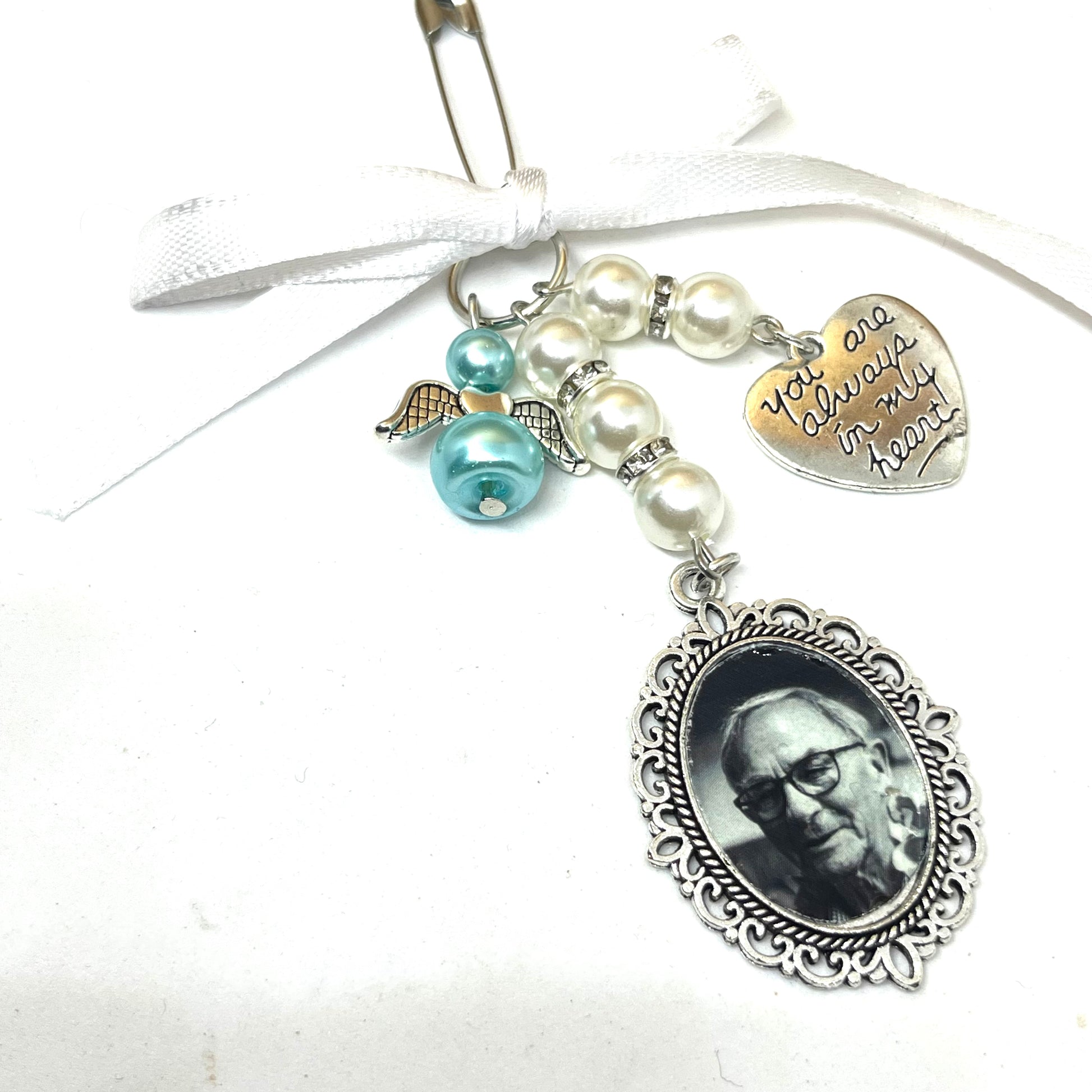 Single silver wedding bouquet charm with pearls, diamantes and an angel on a white ribbon.