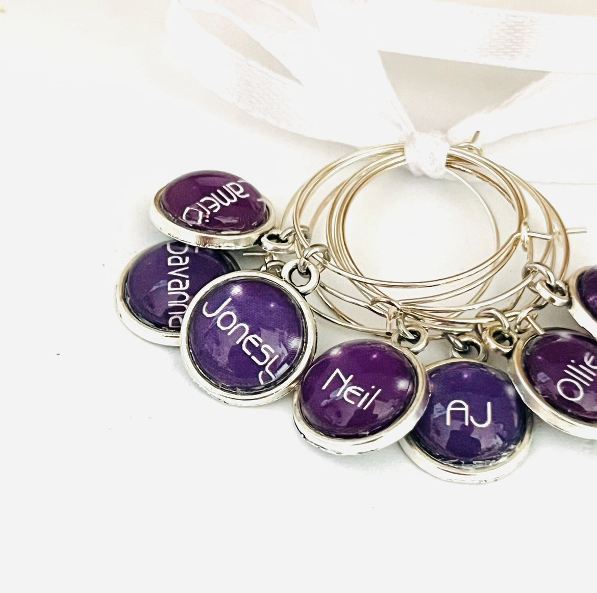 Cloe up of wine glass charms with names on them