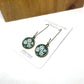Pikiarero ( Clematis) flower postage stamp image  set on a silver 16mm glass dome setting with nickel free long hooks.
