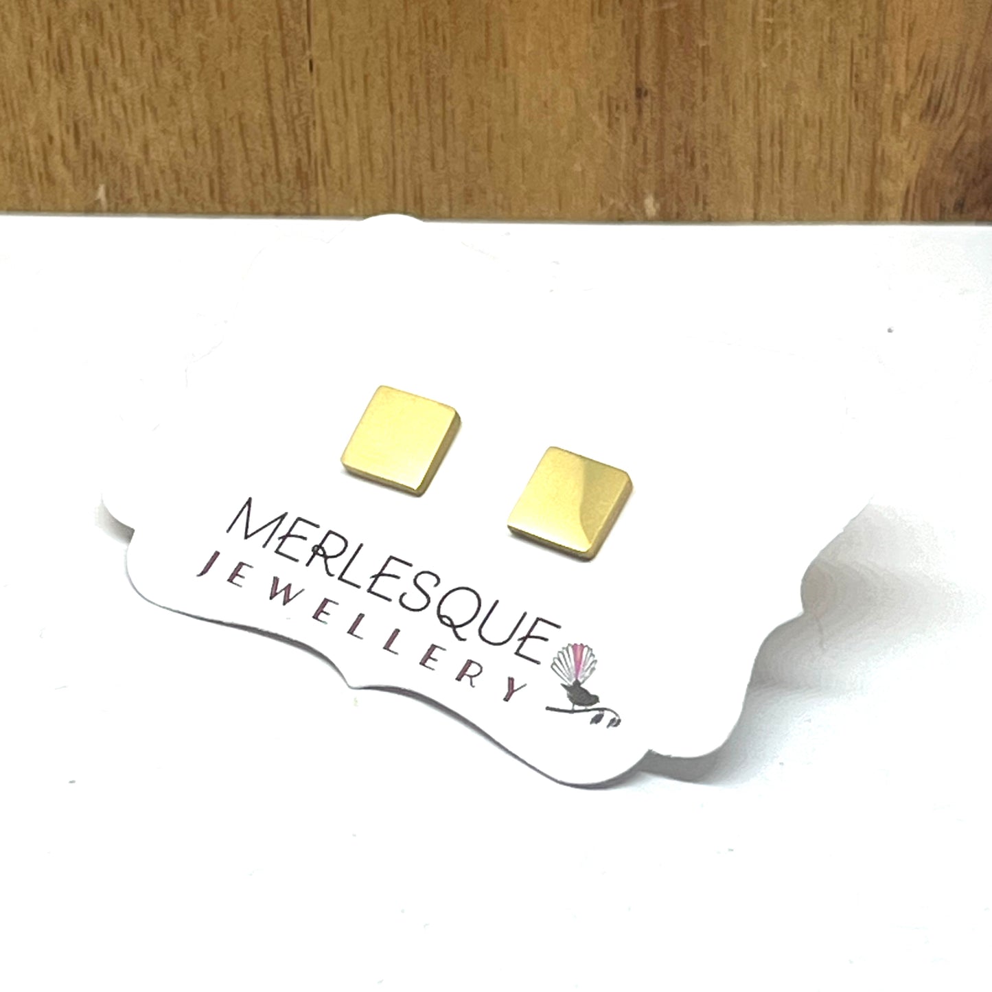 Stainless steel gold square studs.