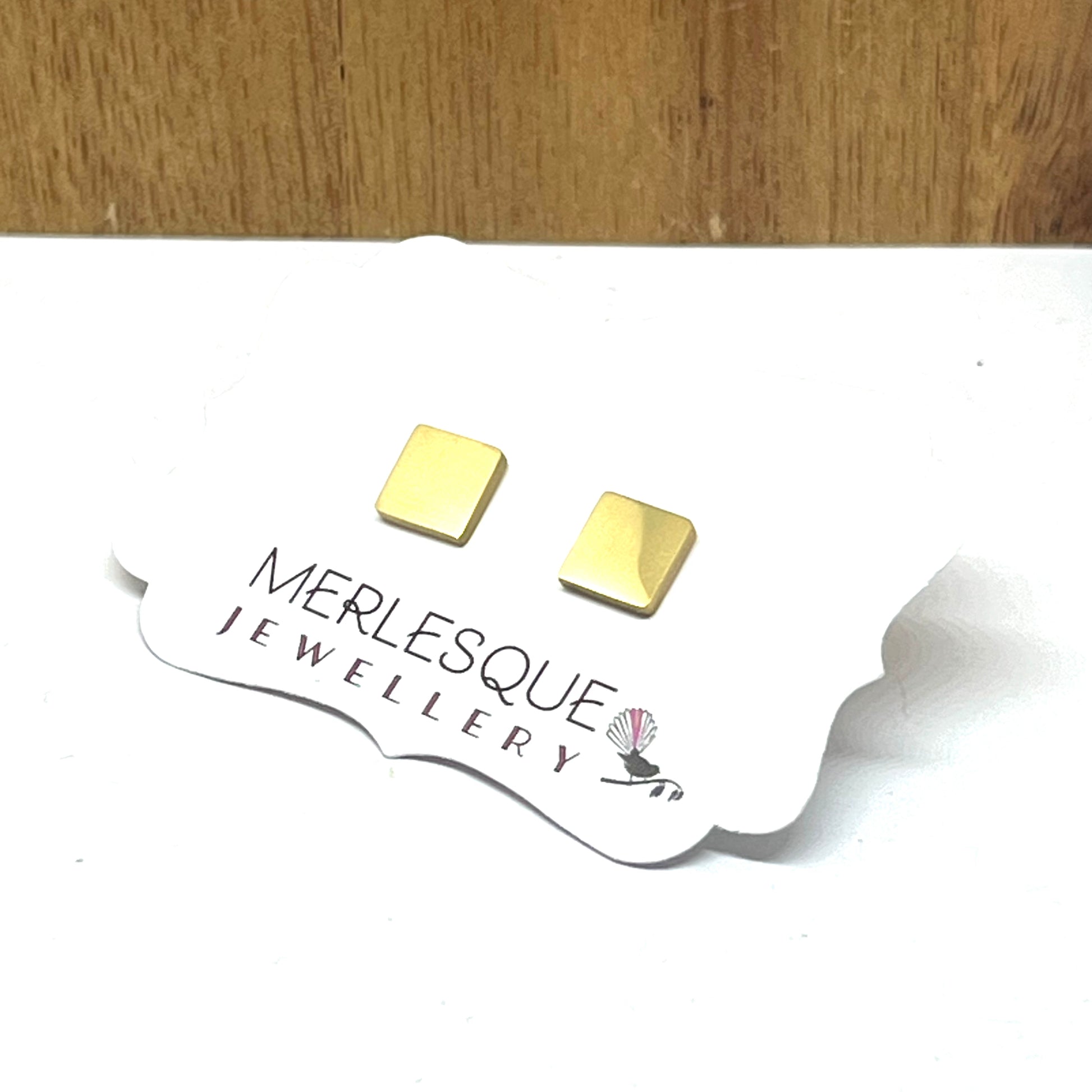 Stainless steel gold square studs.