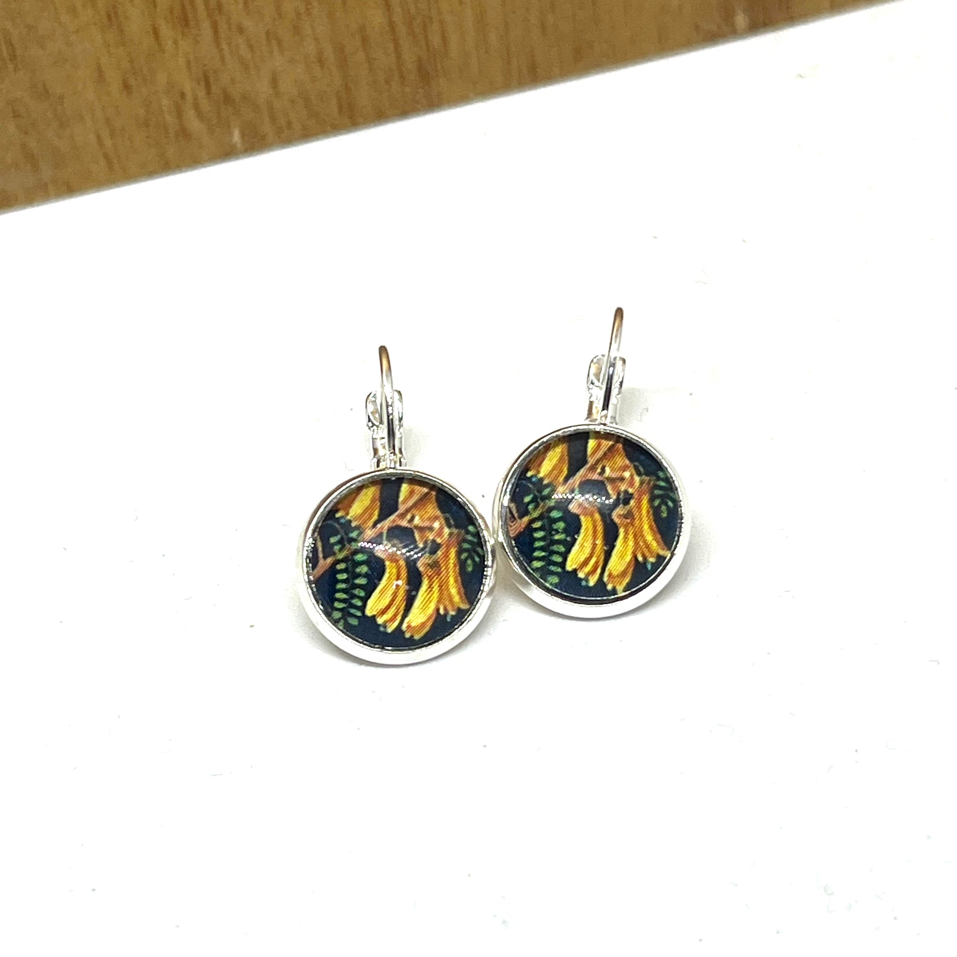Kowhai glass dome earrings on french clasps. New zealand postage stamp image