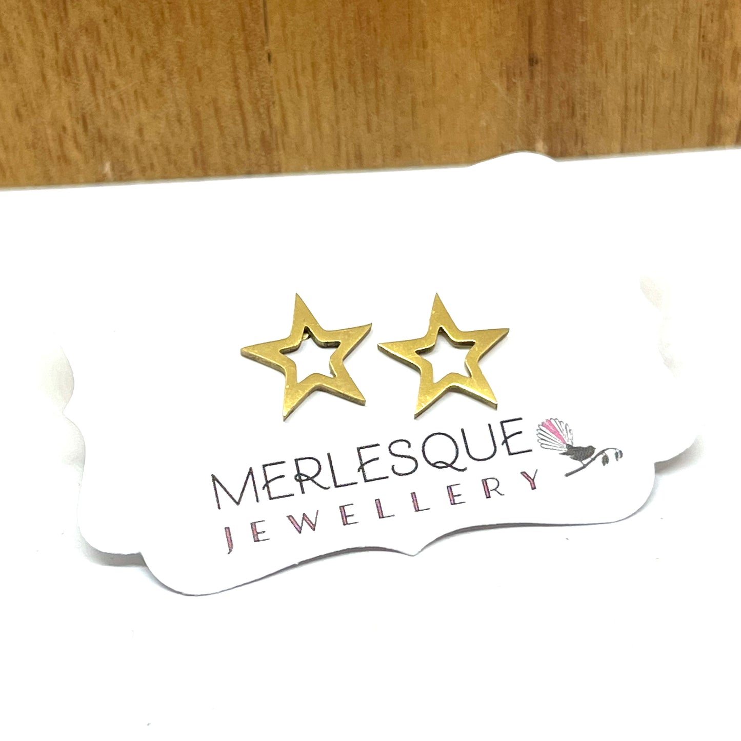 Stainless steel gold star studs.