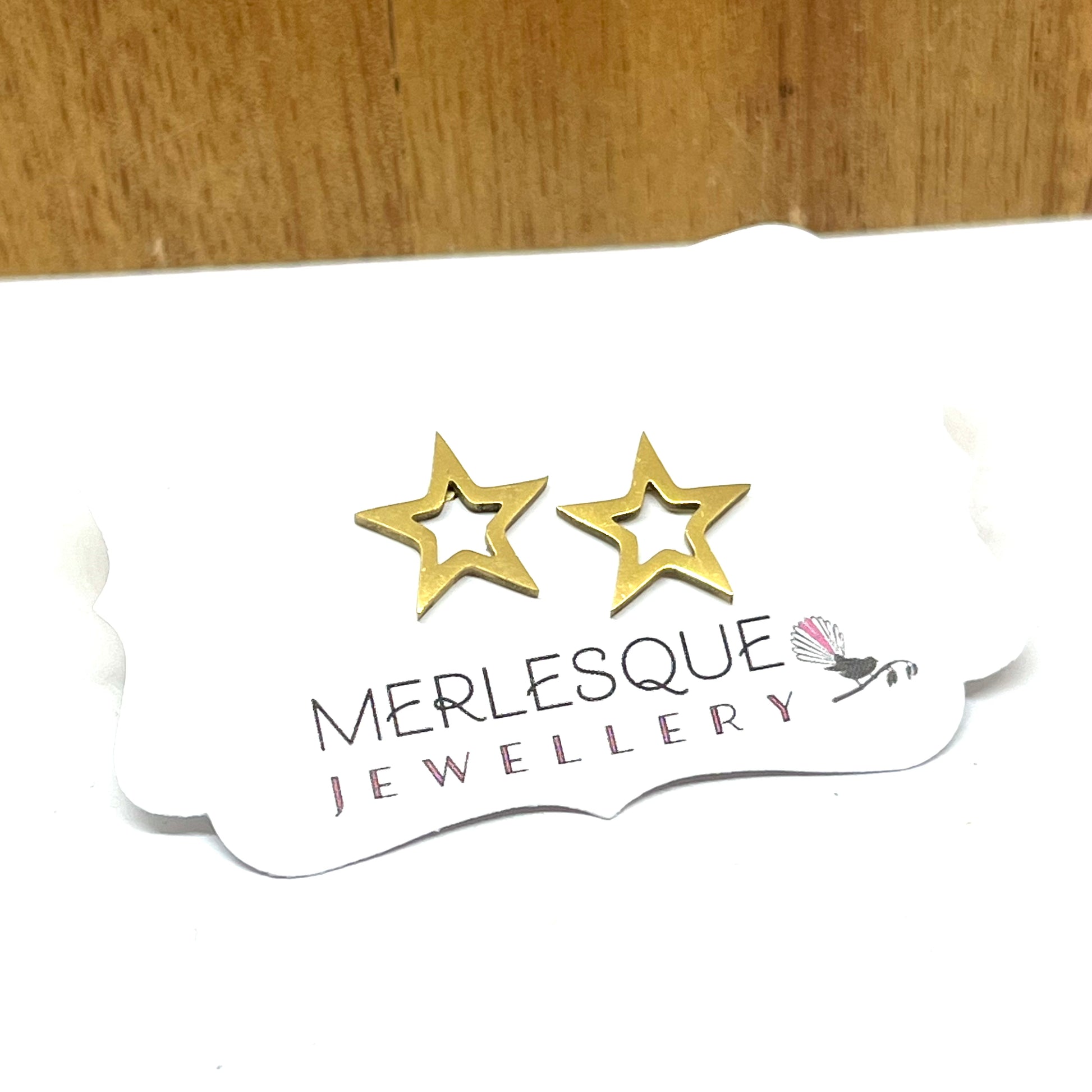 Stainless steel gold star studs.