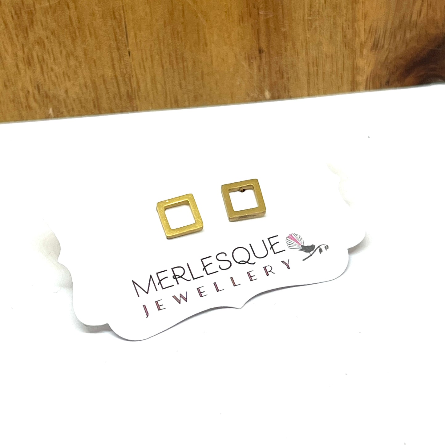Stainless steel open square studs.