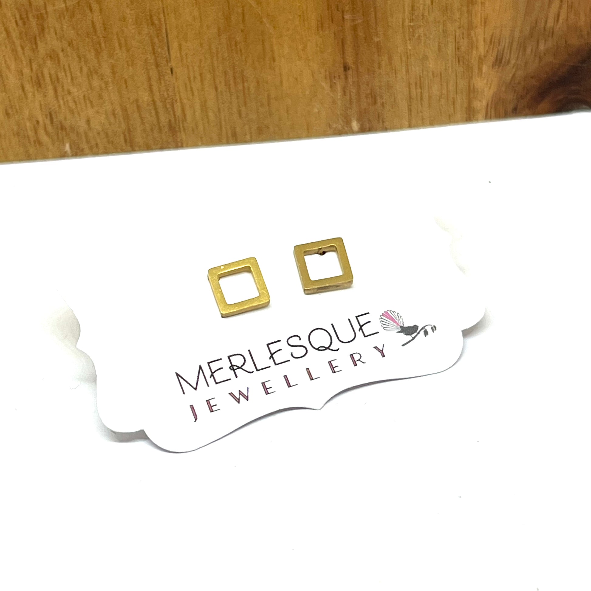 Stainless steel open square studs.