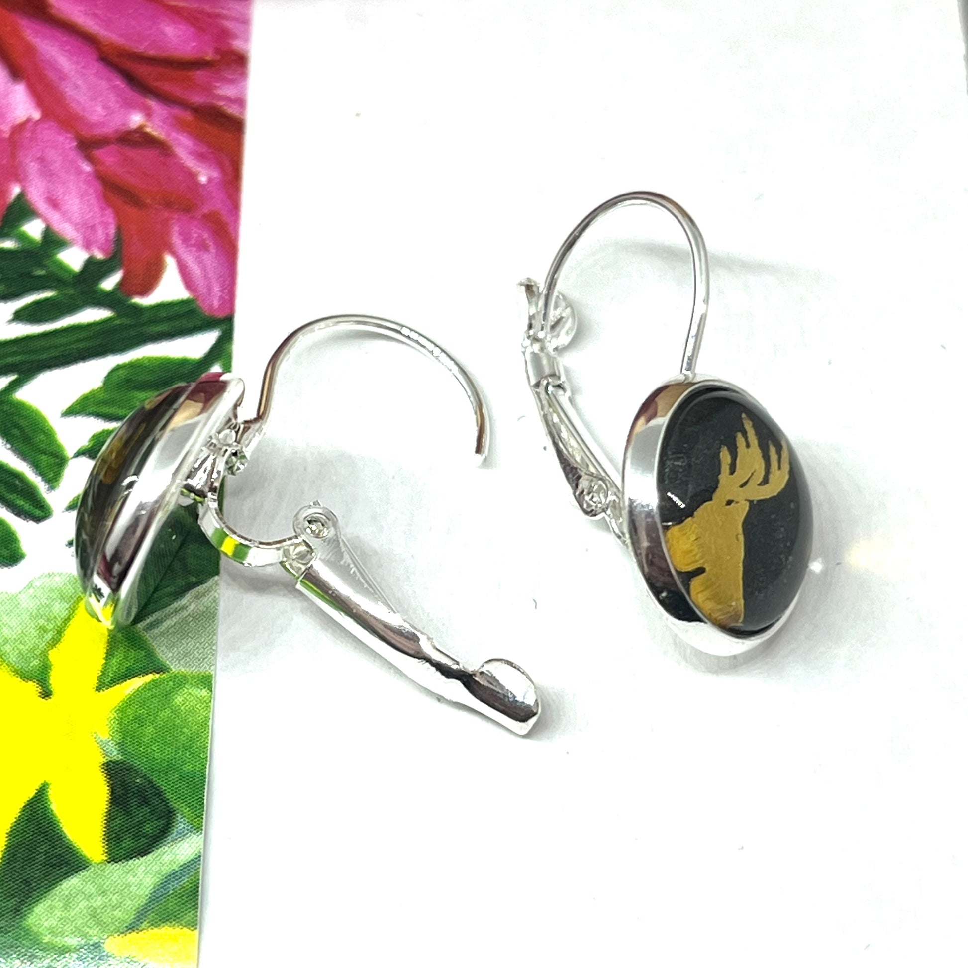 Black and gold glass dome reindeer christmas earrings showing the open clasp.
