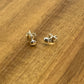 Sterling silver flat head studs displayed on wood