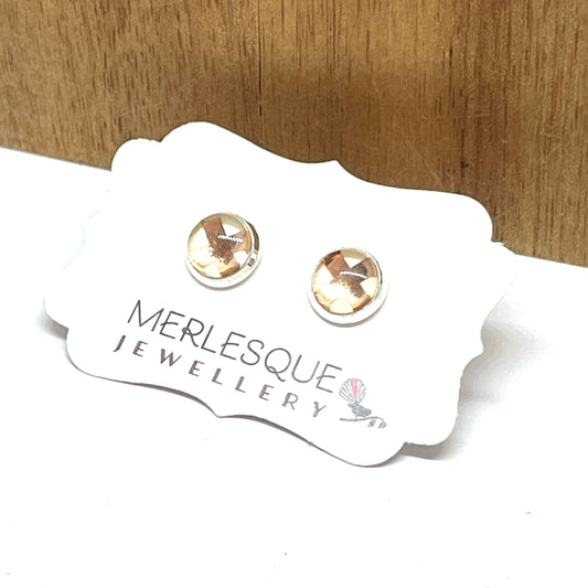 Cream and rose gold glass dome studs.