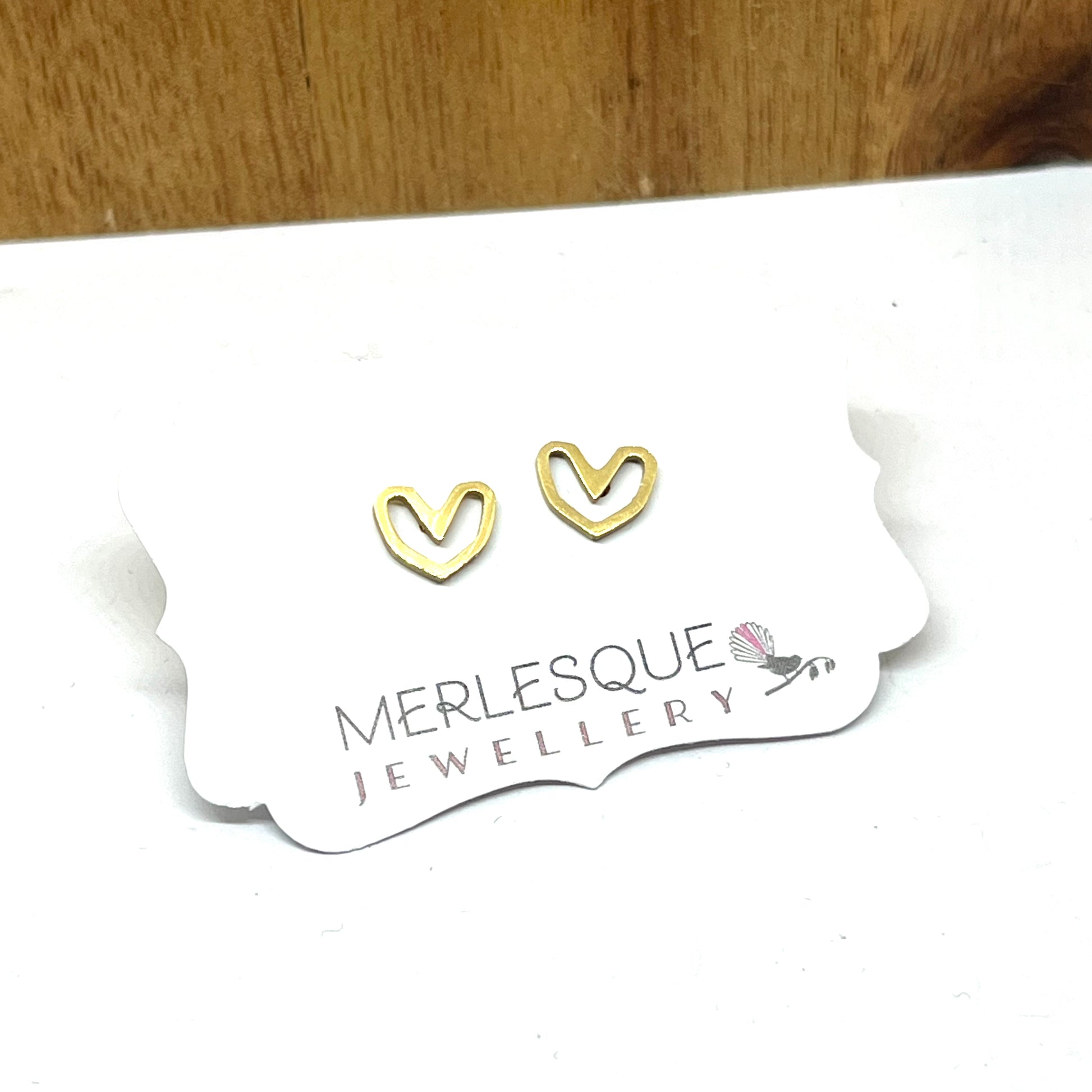 Stainless steel gold open heart studs.