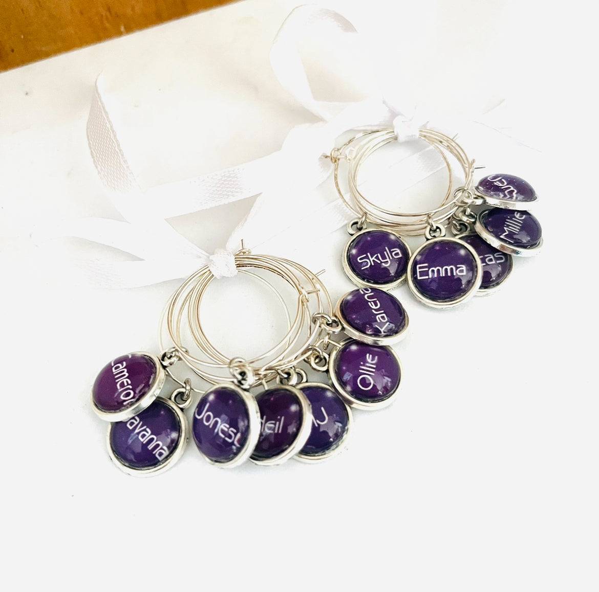 Purple wine glass charms with names on them