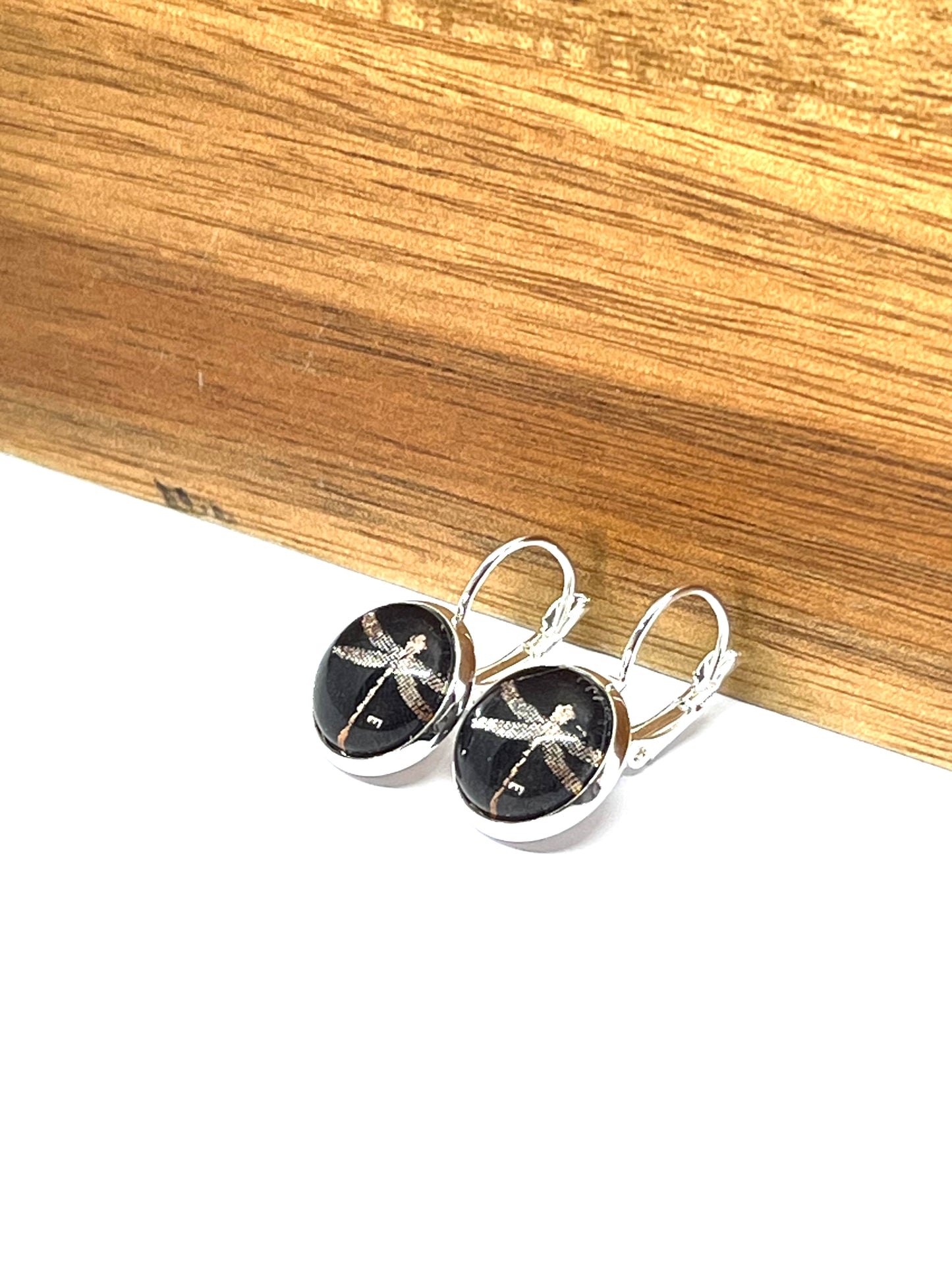 silver dragonfly on a black background glass dome earrings