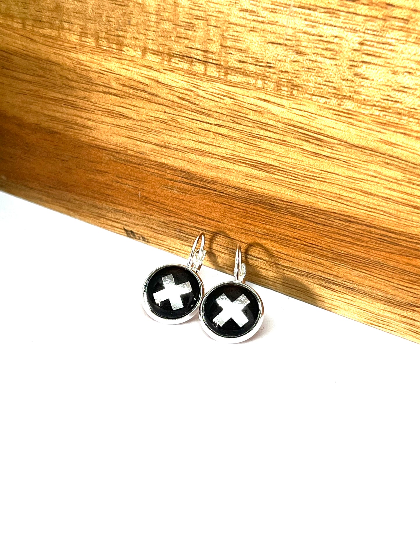 silver kiss on a black background glass dome earrings
