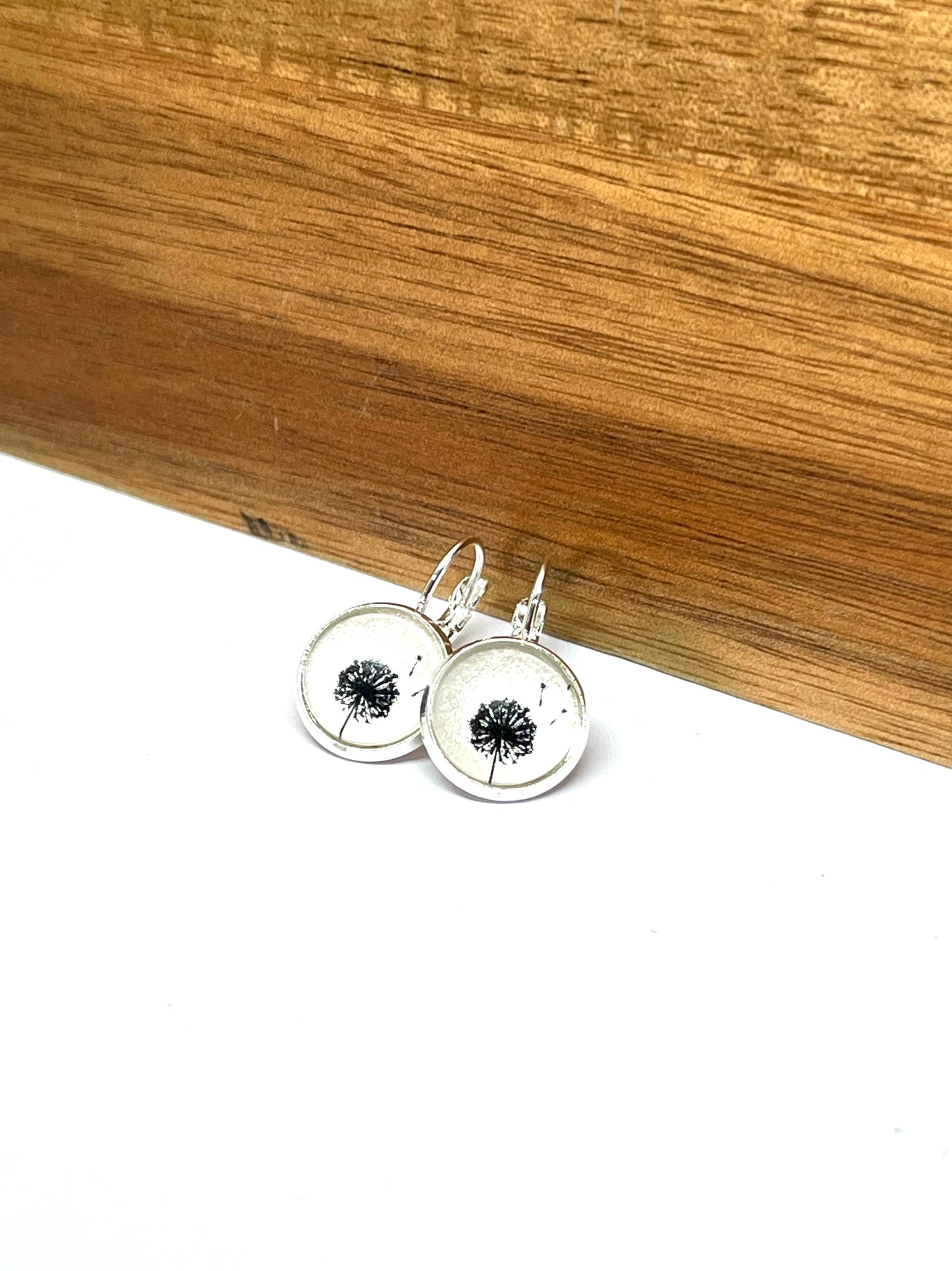Black dandelions on a pearl white background glass dome earrings 