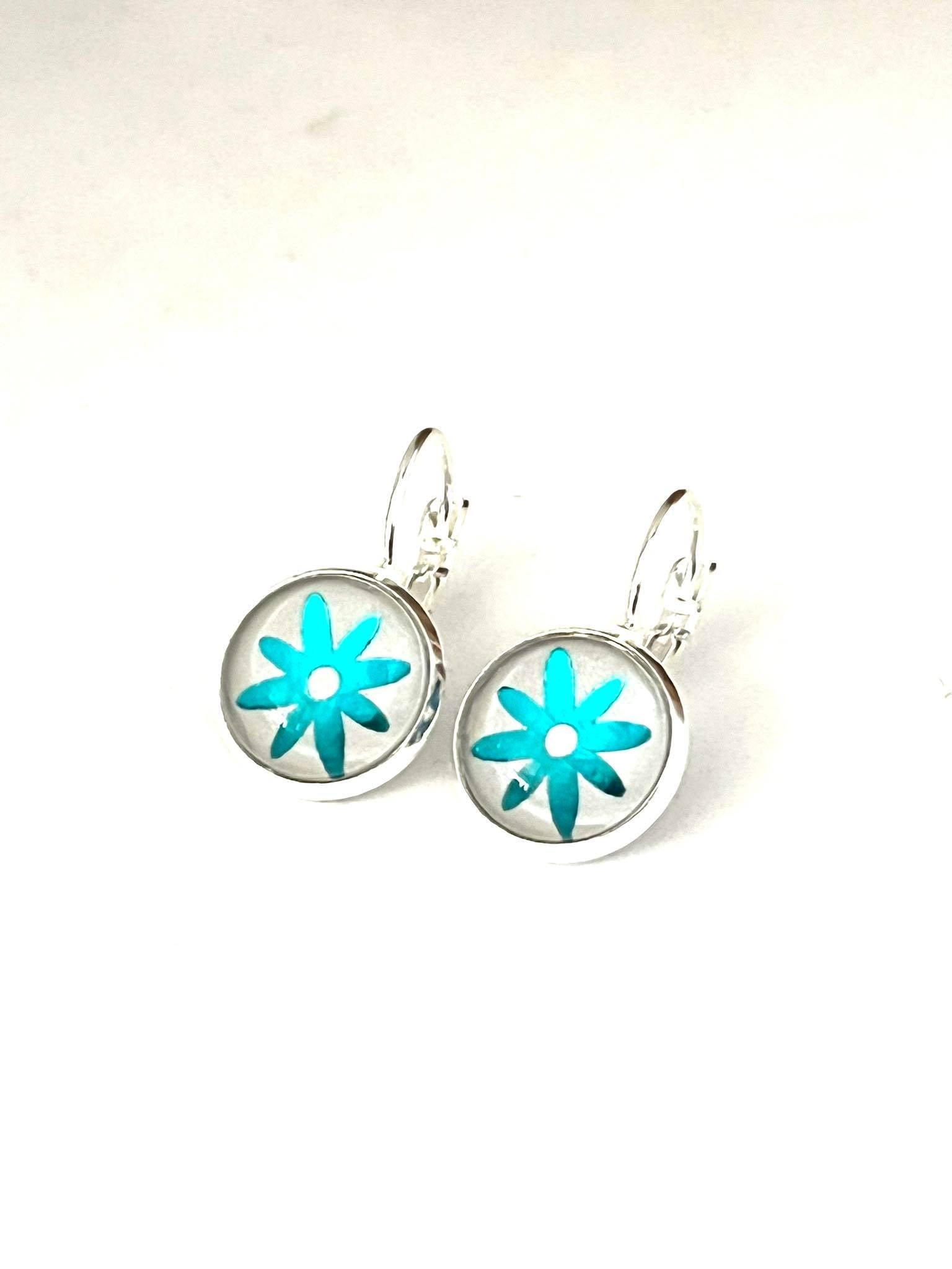 Metallic Aqua blue daisy glass dome earrings in a silver setting