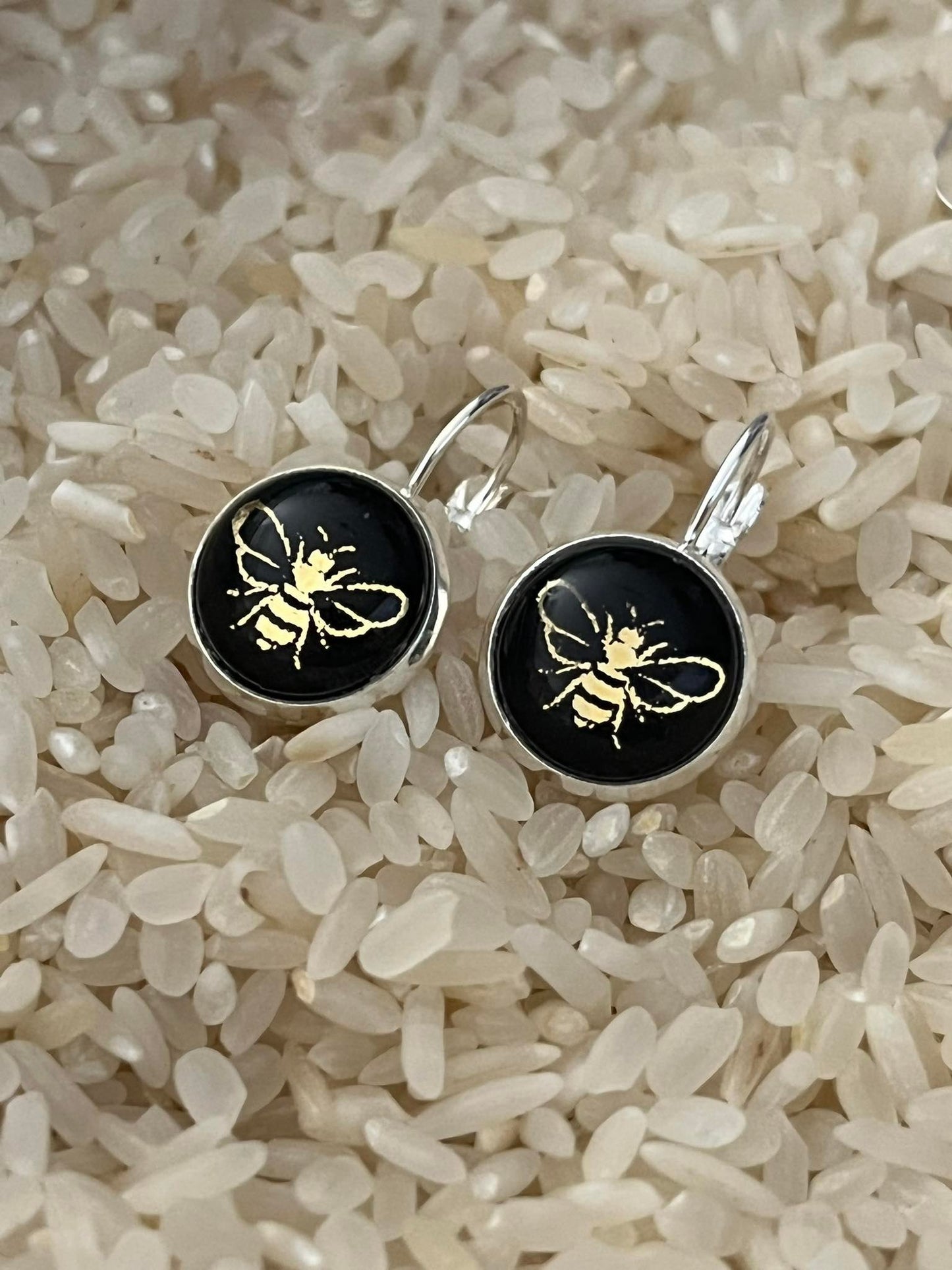 Gold bees on black glass dome earrings 