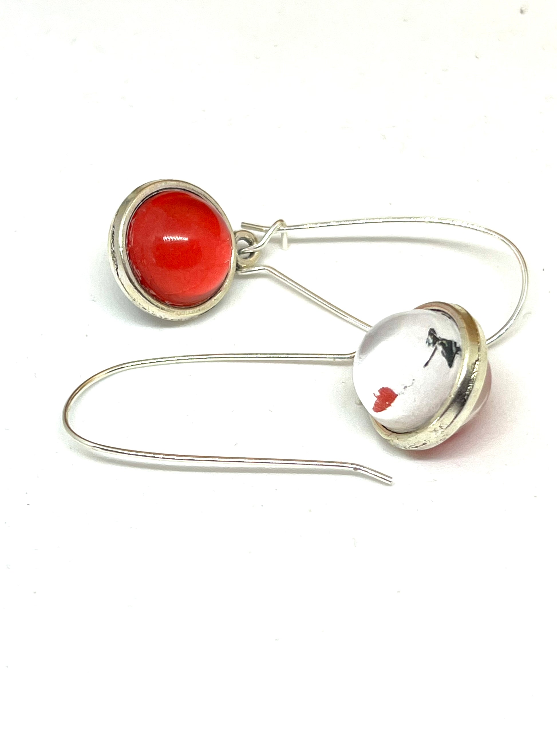 Double sided glass dome earrings with Banksy on one side and red on the other