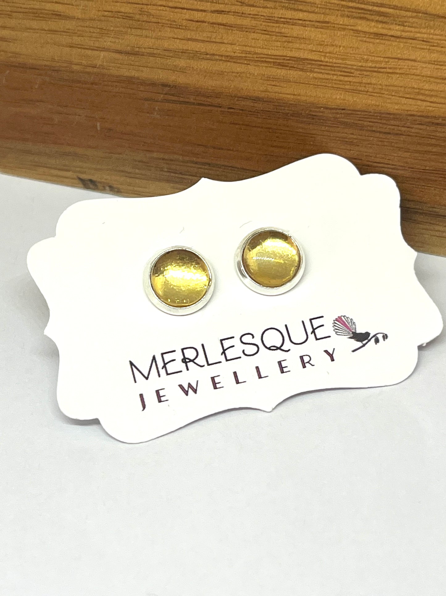 Glass dome gold circle studs.