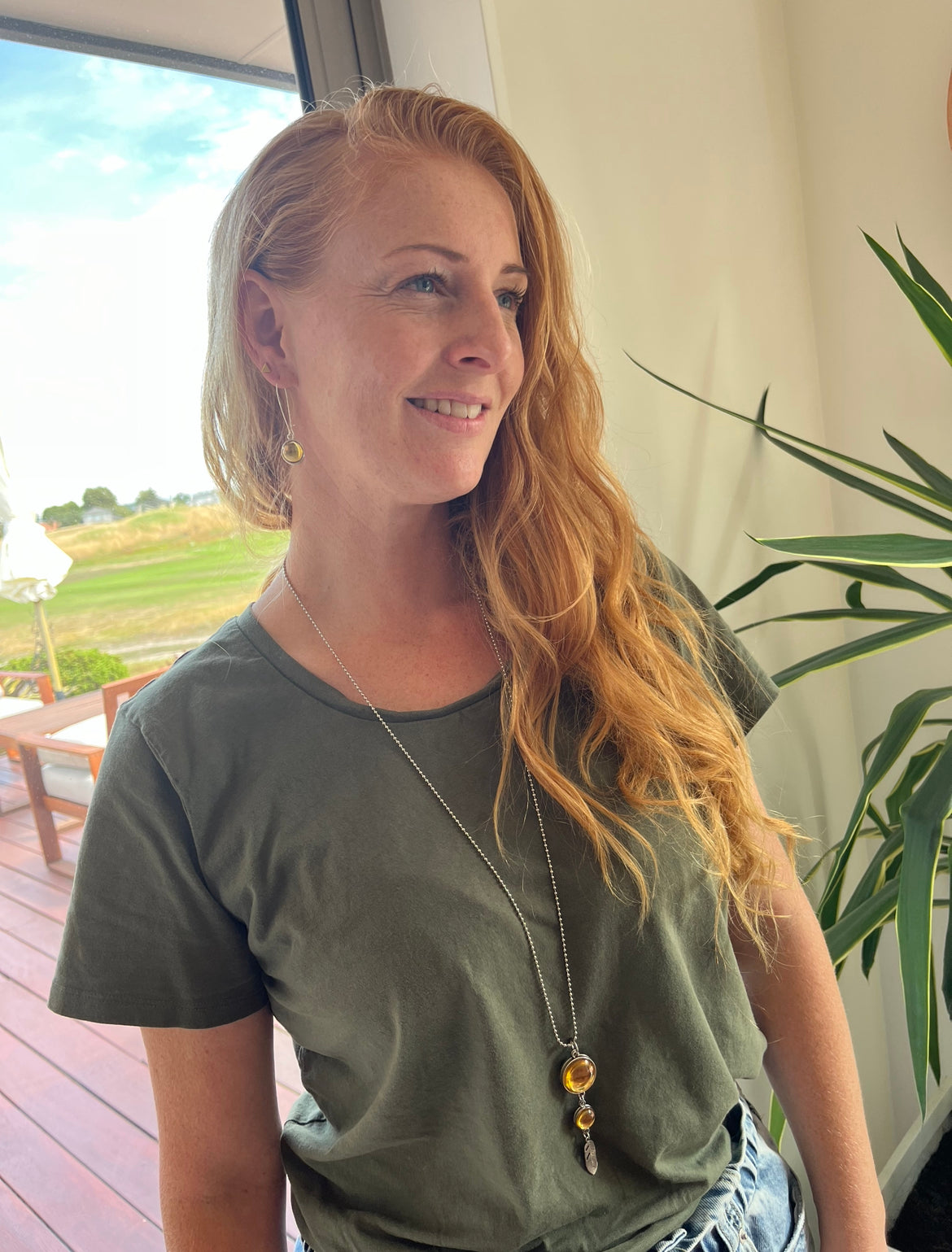 Women with a double sided gold necklace and earrings
