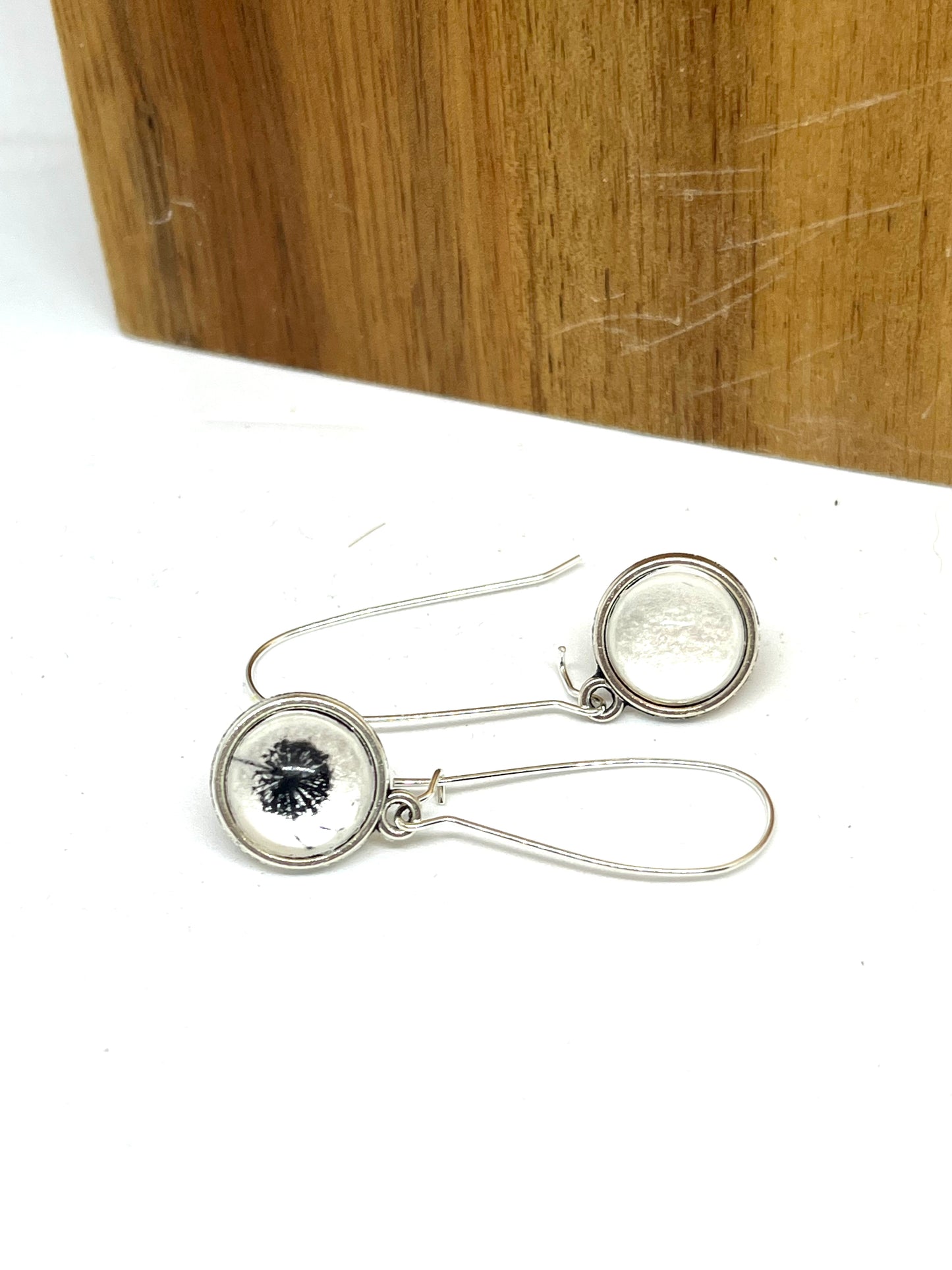 Double sided glass dome earrings with a dandelion on pearl and plain pearl on the other side. 