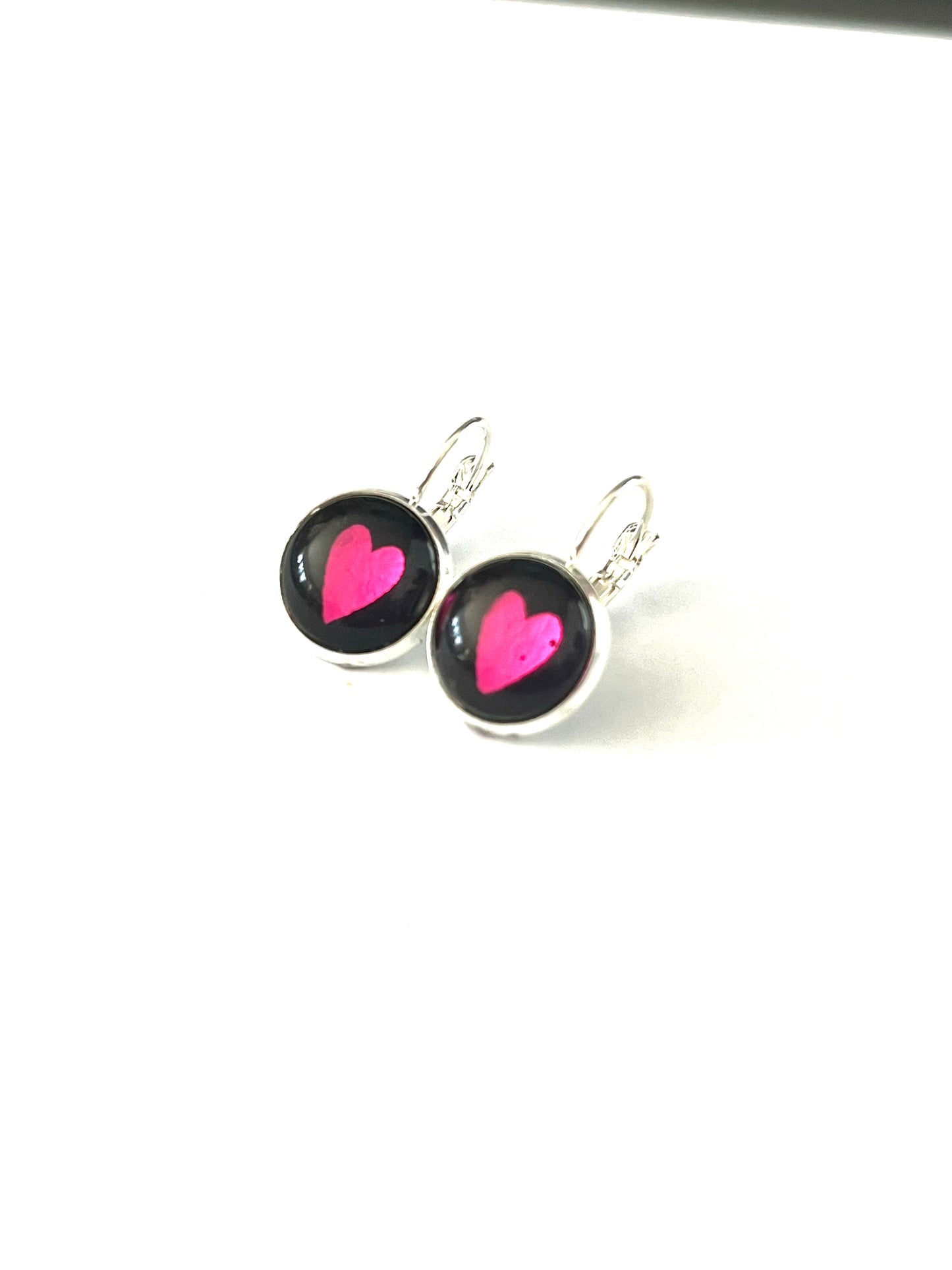 Hot pink hearts on a black background glass dome earrings 