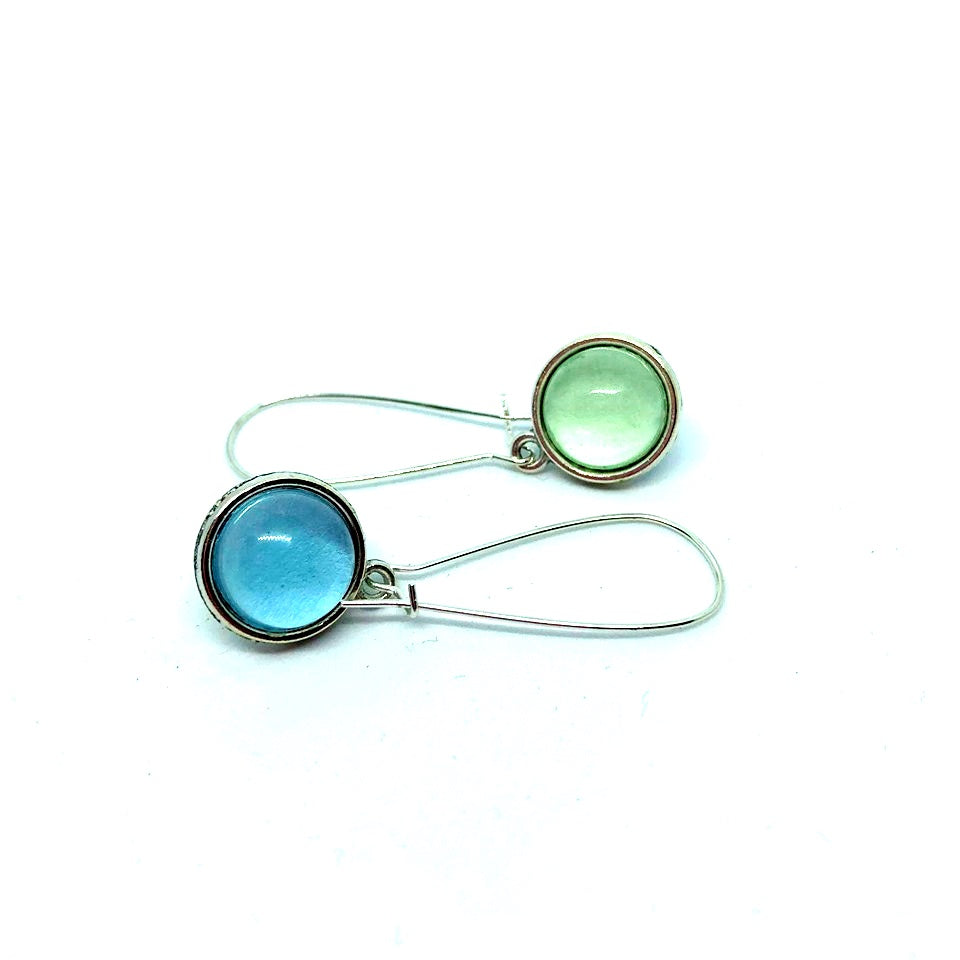Double sided glass dome earrings with pastel blue on one side and soft green other side